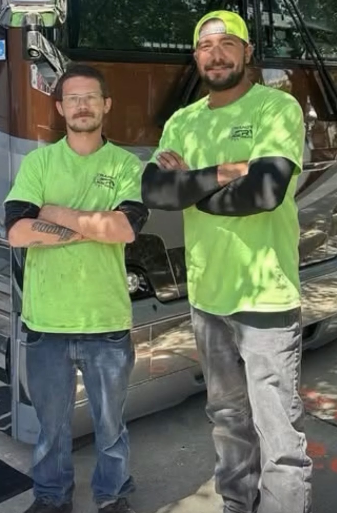 Randy's RV Repair mobile service team standing beside an RV